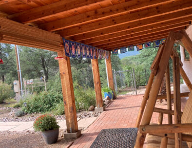 flag-lined patio with swinging bench