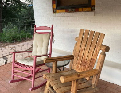 rocking chairs on flag-lined brick porch