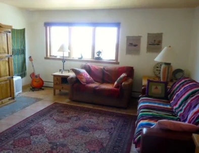 Living room. TV is inside the wooden armoire on the left.