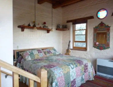 King sized bed and Mexican mirror in Master bedroom